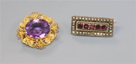 A Victorian yellow metal and amethyst cannetile work brooch and a Victorian garnet and split pearl set brooch.